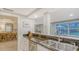 A kitchen features dark countertops, stainless steel appliances, and a sink with views to an adjacent dining area at 4045 Lisbon Pl, Sarasota, FL 34231