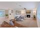 Cozy living room featuring a stone fireplace, ceiling fan, and comfortable seating at 4045 Lisbon Pl, Sarasota, FL 34231