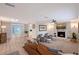 Spacious living room with fireplace, skylight, fan, and modern furnishings at 4045 Lisbon Pl, Sarasota, FL 34231