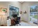 Bright home office with a large window, white shiplap walls and wood floors at 4045 Lisbon Pl, Sarasota, FL 34231
