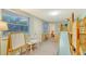 The playroom has a large wooden playset with a slide, ladder, and climbing wall and views to another room at 4045 Lisbon Pl, Sarasota, FL 34231