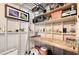 Organized storage area with shelves, fishing equipment and a built-in wooden work bench at 4045 Lisbon Pl, Sarasota, FL 34231