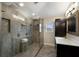 Bright bathroom featuring a spacious glass-enclosed shower with a rainfall shower head and dual vanities at 4255 67Th Avenue E Cir, Sarasota, FL 34243