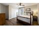 Bedroom with a ceiling fan, wood floors, and a full-size bed at 4255 67Th Avenue E Cir, Sarasota, FL 34243