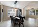 Formal dining area with modern light fixture and an adjacent living area at 4255 67Th Avenue E Cir, Sarasota, FL 34243