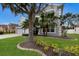 View of the front exterior highlighting the landscaping and mature trees surrounding the two-story house at 4255 67Th Avenue E Cir, Sarasota, FL 34243