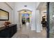 Bright foyer with neutral tile flooring, arched doorways, a large mirror and an open view to the living and dining rooms at 4255 67Th Avenue E Cir, Sarasota, FL 34243