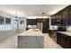 Open kitchen with stainless steel appliances, island, quartz countertops and dark wood cabinets at 4255 67Th Avenue E Cir, Sarasota, FL 34243