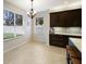 Bright kitchen nook with tile flooring, modern chandelier, and stainless steel coffee machine on the counter at 4255 67Th Avenue E Cir, Sarasota, FL 34243