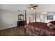 Main bedroom with a four-poster bed, hardwood floors, and an ensuite bathroom entrance at 4255 67Th Avenue E Cir, Sarasota, FL 34243