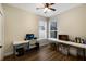 Office with two windows, wood floors, two tables, and a ceiling fan at 4255 67Th Avenue E Cir, Sarasota, FL 34243