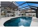 Beautiful outdoor living space with a screened-in pool and an outdoor kitchen at 4255 67Th Avenue E Cir, Sarasota, FL 34243