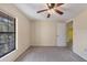 Carpeted bedroom featuring a ceiling fan and a view to the outside at 4414 Spicewood Dr # H, Bradenton, FL 34208
