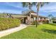 Well-maintained home exterior with mature landscaping and covered entrance at 4414 Spicewood Dr # H, Bradenton, FL 34208