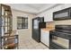 Cozy kitchen features black appliances, ample cabinet space, and a window view at 4414 Spicewood Dr # H, Bradenton, FL 34208