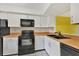 Kitchen featuring black appliances, white cabinets, and plenty of counter space at 4414 Spicewood Dr # H, Bradenton, FL 34208