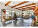 Spacious living room with exposed beams, tile floor and large windows overlooking the pool at 4414 Spicewood Dr # H, Bradenton, FL 34208