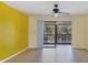 Spacious living room with a ceiling fan and sliding doors leading to an outdoor area at 4414 Spicewood Dr # H, Bradenton, FL 34208