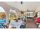 Enjoy this patio featuring arched windows, ceiling fans, and ample seating perfect for outdoor dining or relaxation at 4414 Spicewood Dr # H, Bradenton, FL 34208