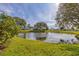 Scenic view of pond surrounded by lush greenery and homes in the background at 4414 Spicewood Dr # H, Bradenton, FL 34208