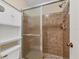 Shower with neutral tile, glass doors and built in storage at 4414 Spicewood Dr # H, Bradenton, FL 34208