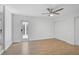 Bedroom showcases the wood floors, white block-walls and natural light from patio at 4455 Emerald Ridge Dr, Sarasota, FL 34233