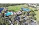 Aerial view of community amenities: pool, tennis courts, clubhouse, and manicured landscaping at 4744 105Th E Ave, Parrish, FL 34219