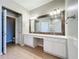 Spacious bathroom with a large mirror, double vanity, white cabinets and tile flooring at 4744 105Th E Ave, Parrish, FL 34219
