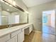 Bathroom featuring double sink vanity with large mirror and modern fixtures at 4744 105Th E Ave, Parrish, FL 34219