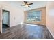 Bright bedroom featuring hardwood-style flooring and large window with backyard view at 4744 105Th E Ave, Parrish, FL 34219