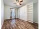 Bedroom with built-in cabinets and shelving units and wood floors at 4744 105Th E Ave, Parrish, FL 34219