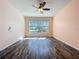 Bright bedroom with hardwood-style flooring and large window with a view at 4744 105Th E Ave, Parrish, FL 34219