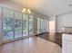 Bright dining area boasts plantation shutters, stylish chandelier, and easy access to the outdoor patio at 4744 105Th E Ave, Parrish, FL 34219
