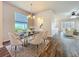Elegant dining room featuring a modern chandelier and view into the bright living room at 4744 105Th E Ave, Parrish, FL 34219