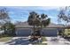 Well-maintained homes with two-car garages, green lawns, palm trees, and a shared mailbox at 4744 105Th E Ave, Parrish, FL 34219