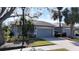 Charming home with a well-manicured lawn, landscaping, and an attached two-car garage at 4744 105Th E Ave, Parrish, FL 34219