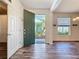Welcoming foyer showcasing hardwood floors and a view of the beautifully landscaped front yard at 4744 105Th E Ave, Parrish, FL 34219