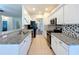 Galley kitchen with granite countertops, stainless steel appliances, and white cabinets offer plenty of space at 4744 105Th E Ave, Parrish, FL 34219