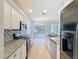 Modern kitchen featuring granite countertops, stainless steel appliances, and ample cabinet space at 4744 105Th E Ave, Parrish, FL 34219