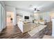 Cozy living room featuring stylish wood floors, a ceiling fan, and bright white walls at 4744 105Th E Ave, Parrish, FL 34219