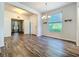 Open-concept living space with wood floors, showcasing a view through to a bedroom at 4744 105Th E Ave, Parrish, FL 34219