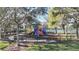 Community playground featuring a variety of colorful play structures, benches, and safety fencing for a fun Gathering experience at 4744 105Th E Ave, Parrish, FL 34219