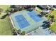 Aerial view showcases the community's well-maintained tennis courts with a basketball court; a great amenity for residents at 4744 105Th E Ave, Parrish, FL 34219
