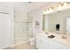 Modern bathroom featuring a glass-enclosed shower, double sink vanity, and neutral color palette for a clean, contemporary feel at 5118 78Th St E Cir, Bradenton, FL 34203
