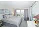 Bedroom features windows, neutral tones, and comfortable bedding at 5118 78Th St E Cir, Bradenton, FL 34203