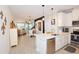 Open-concept kitchen featuring modern appliances and flowing seamlessly into the dining and living areas at 5118 78Th St E Cir, Bradenton, FL 34203
