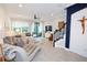 Open living area with tile flooring, a ceiling fan, and staircase to the upper level at 5118 78Th St E Cir, Bradenton, FL 34203