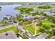 A clubhouse and pool area are seen from above surrounded by green areas and a lake at 5119 Admiral Pointe Dr, Apollo Beach, FL 33572