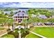 Clubhouse with palm trees, a red truck parked out front, green space, and some parked cars at 5119 Admiral Pointe Dr, Apollo Beach, FL 33572