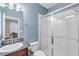 Bathroom featuring a granite sink, toilet, and a glassed shower at 5119 Admiral Pointe Dr, Apollo Beach, FL 33572